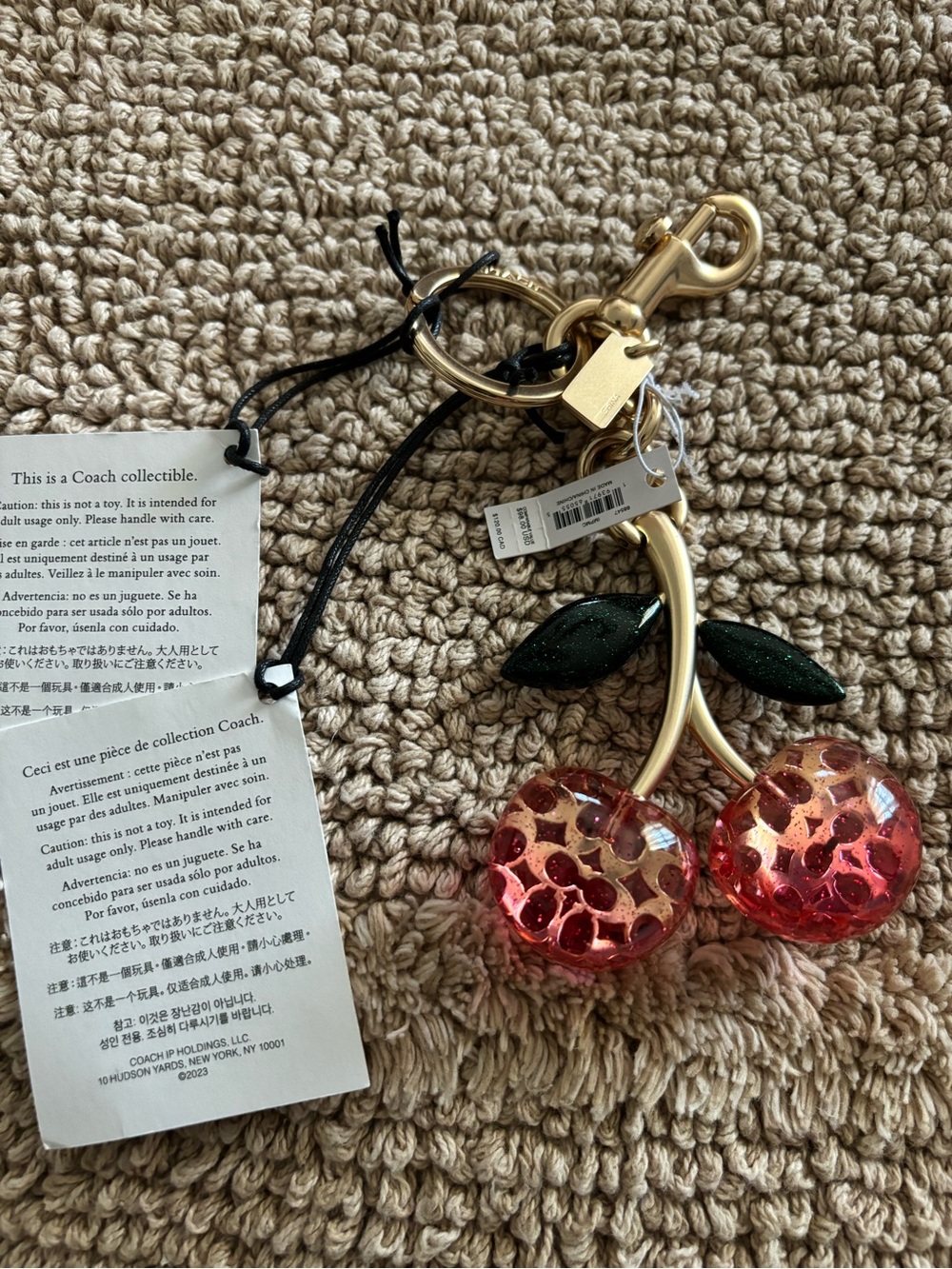 Coach Pink Cherry Resin Key Charm with Gold-Tone Hardware and Dark Green Leaves